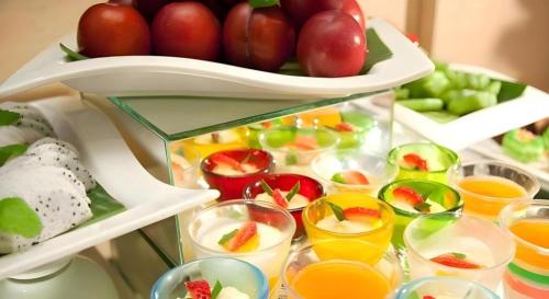 a refrigerator filled with lots of fruit and juice at Hotel Miramar Singapore in Singapore