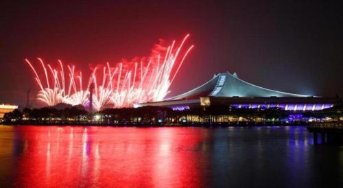 a large building with fireworks in the sky at night at Hotel Miramar Singapore in Singapore