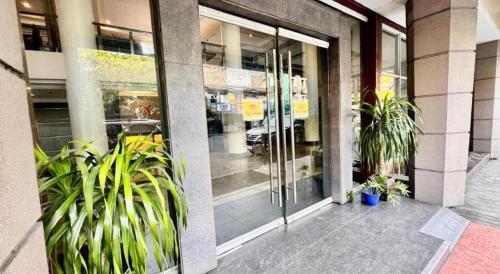a building with potted plants in front of a store at MO2 Westown Hotel San Juan in Bacolod