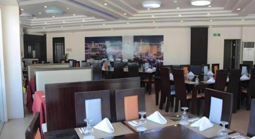 a dining room with tables and chairs in a restaurant at Subic Bay Venezia in Olongapo
