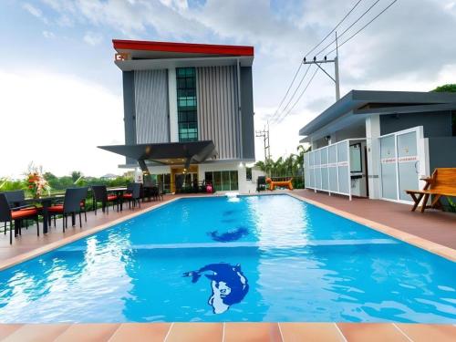 a swimming pool with a mermaid stencil on the side of a building at GT Residence Hotel in Buriram
