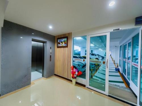 a room with a hallway with a view of a car dealership at GT Residence Hotel in Buriram