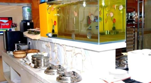 a buffet line with pots and pans on a counter at Jinjiang Inn Style Shenyang The Palace Huaiyuan Gate in Shenyang