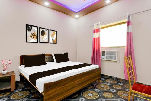 a bedroom with a king sized bed in a room at Hotel O Rajaram Singh Blessing Garden And Hotel in Prayagraj