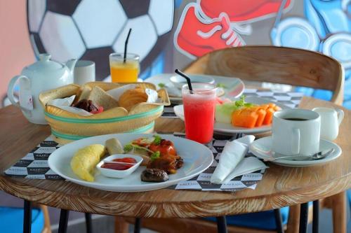 a table with two plates of breakfast food on it at Umah Bali Suites in Denpasar