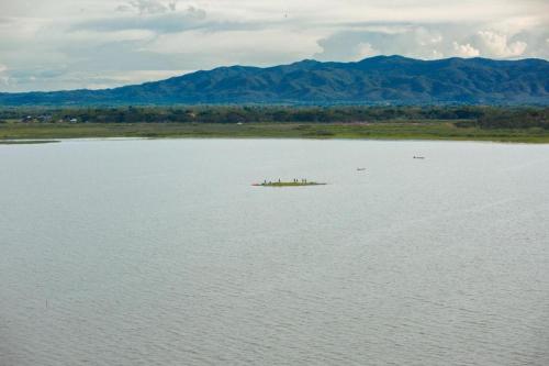 a group of people standing on a large body of water at Phuglong Hotel in Phayao