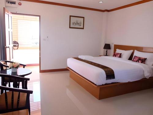 a bedroom with a large bed and a window at Thatphanom View Hotel Nakhon in Nakhon Phanom