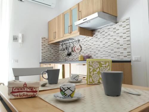 a kitchen with a wooden table with a counter top at Nonna Titta Casa Vacanze in Matera