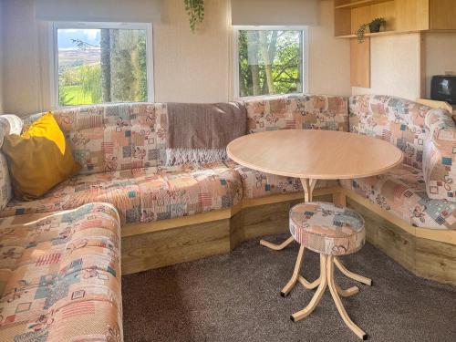 a living room with a couch and a table at Emerald Pines - Uk50577 in Blanchland
