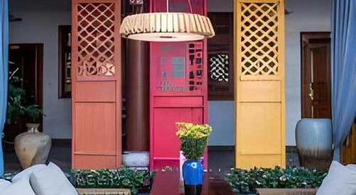 a vase filled with flowers in front of a building at Dali Four Seasons Hostel in Dali Ancient Town
