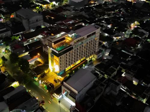 an overhead view of a building in a city at night at Java Lotus Hotel Jember in Jember