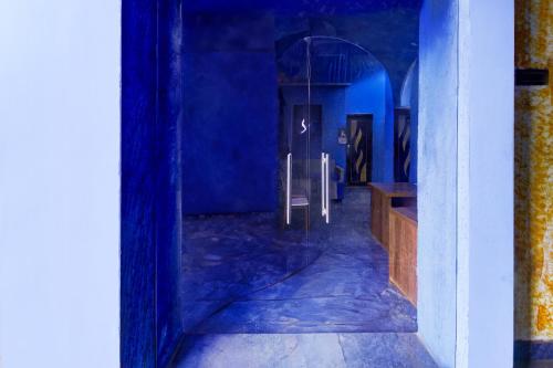 a blue room with a table and a mirror at Super Collection O Nagapattinam Bus Terminal Formerly Yazhisai Residency in Nāgappattinam