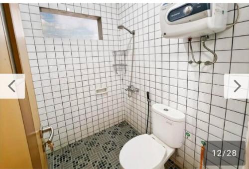 a small bathroom with a toilet and a window at Newly Large Villa 3BR Dago Bandung by 2ndHome in Bandung