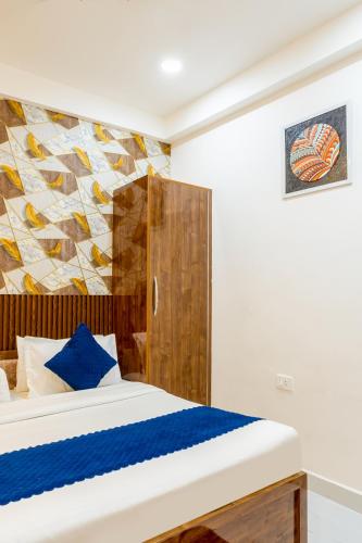 a bedroom with a bed and a painting on the wall at Honeyveils Palace Hotel - Behind Indian Expo Mart in Greater Noida
