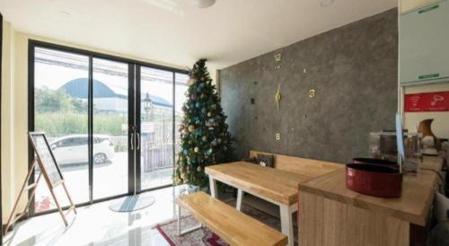 a living room with a christmas tree in the corner at 5BOX Donmuang Airport in Bangkok