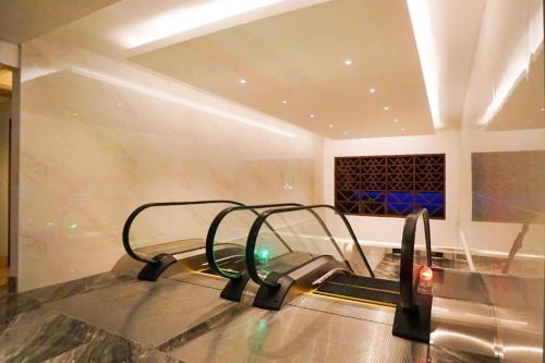 a room with a table with a machine in it at Hotel Niagara Parapat in Parapat