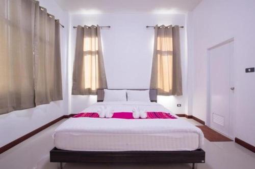 Un ou plusieurs lits dans un hébergement de l'établissement Bees Smile Hotel