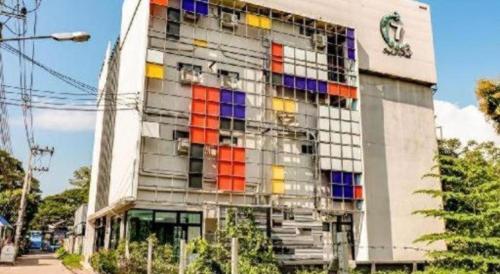a building with colorful windows on the side of it at OYO 412 7 Days Hotel in Chiang Mai