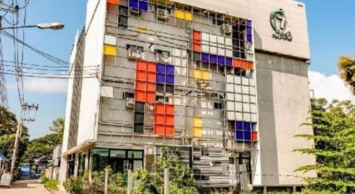 a building with colorful windows on the side of it at OYO 412 7 Days Hotel in Chiang Mai