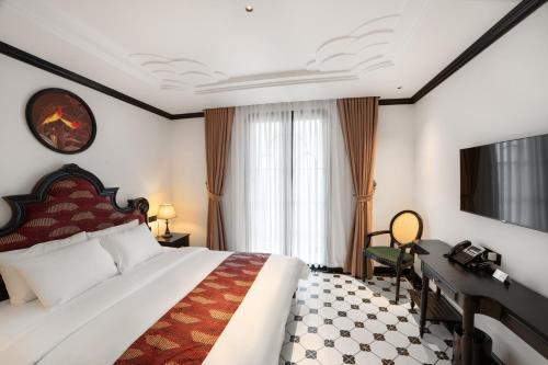 Postel nebo postele na pokoji v ubytování C'lau Hotel