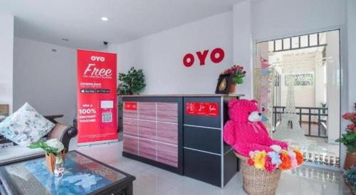 a red teddy bear sitting on a counter in a store at Super OYO 662 Malee Bunga Hotel in Si Racha