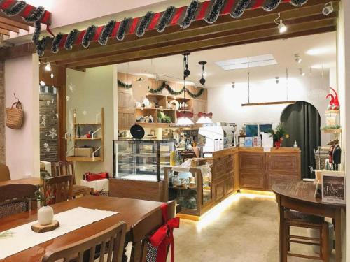 a room with a table and a kitchen at Need a Nap Hostel Phrae in Phrae
