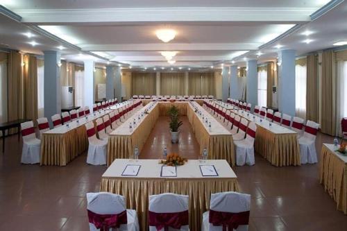 a large banquet hall with long tables and chairs at Hai Au Hotel in Hai Phong