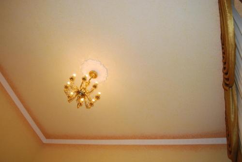 a chandelier hanging from a ceiling in a room at Villa Europa in Mielno