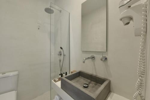 a bathroom with a sink and a shower at Kefalonia Grand in Argostoli