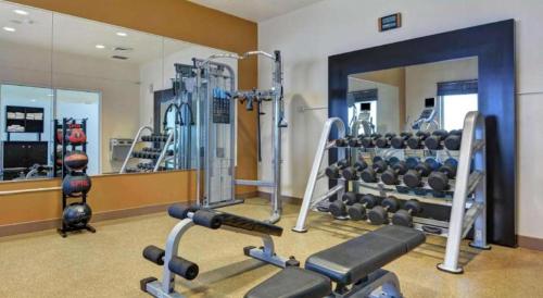 a gym with several tread machines and a mirror at Hilton Garden Inn Oshkosh in Oshkosh