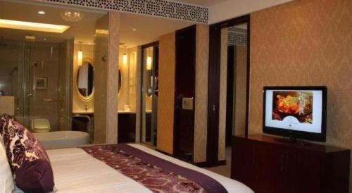 Katil atau katil-katil dalam bilik di New Century Hotel Zaozhuang Fengming