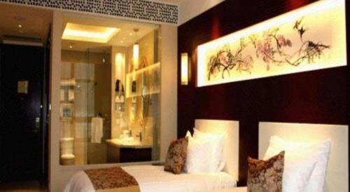 Katil atau katil-katil dalam bilik di New Century Hotel Zaozhuang Fengming