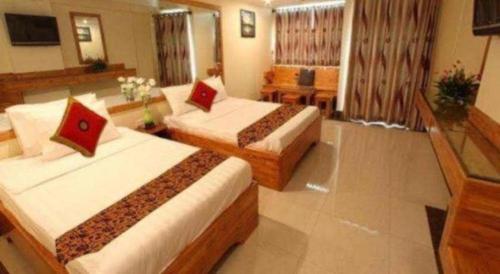 a hotel room with two beds in a room at Lucky Star Hotel in Phnom Penh
