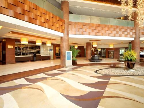 a lobby of a hotel with a zebra patterned floor at Kunshan Newport Hotel in Suzhou