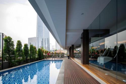 a large building with a swimming pool in a city at The Day Residence in Jakarta