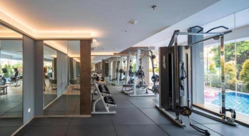 a gym in a building with a swimming pool at The Day Residence in Jakarta