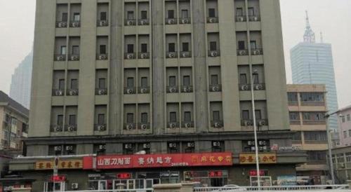 a large building in the middle of a city at Jinjiang Inn Tianjin Station Jinwan Square in Tianjin