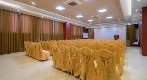 a banquet hall with rows of chairs and a stage at Vienna Hotel Guiyang Jiaxiulou Jichang Road in Guiyang