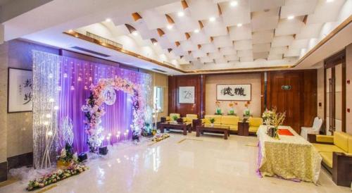 a large room with a purple curtain and a living room at Huachen Kenzo Hotel Hangzhou in Hangzhou