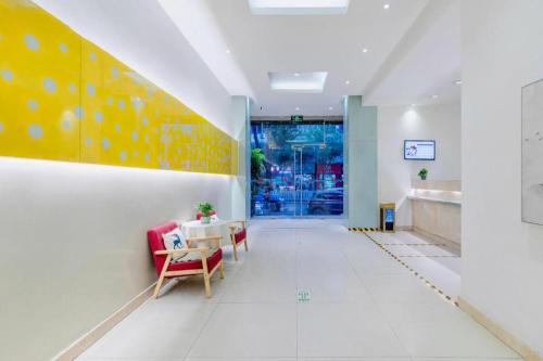 a hallway with a table and chairs in a building at Jinjiang Inn Wenzhou Shuangyu The Terminal in Wenzhou