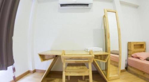 a room with a desk and a mirror and a bed at Maximize Brand New Hostel Udonthani in Udon Thani