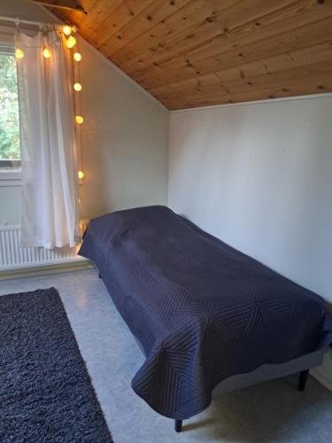 a bedroom with a bed in a room with a window at Aalto A - A whole house with 5 bedrooms and a woodburning sauna in Oulu