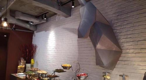a brick wall with a bunch of food on it at YUNIK-Shanghai Zhongshan Park Yan'an Xi Road in Shanghai