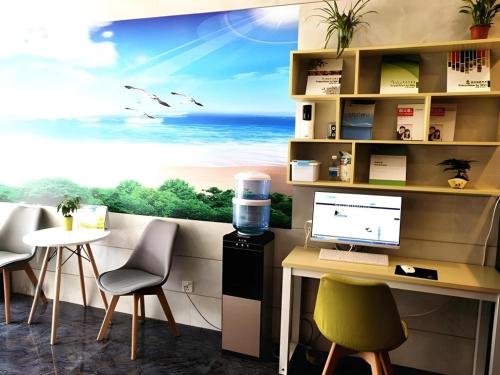 an office with a desk with a computer and a window at Shell Hotel Shanghai Baoshan Meilanhu Luosheng Road in Shanghai