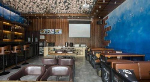 a dining room with leather chairs and a screen at GreenTree Inn Changzhou Wujin Bus Station in Changzhou