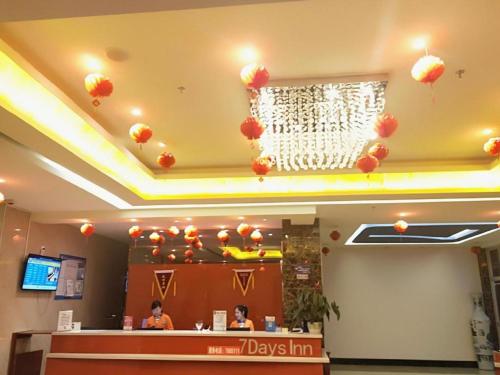 a fast food restaurant with red balloons on the ceiling at 7 Days Inn Yining Xintiandi in Kipekyüzi