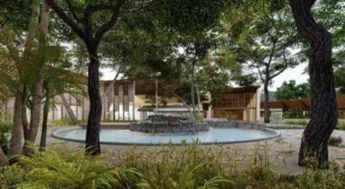 a fountain in the middle of a park with trees at RXV Wellness Village in Nakhon Pathom