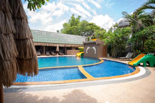 a swimming pool with a slide and a playground at Lanta Riviera Beach Resort in Ko Lanta