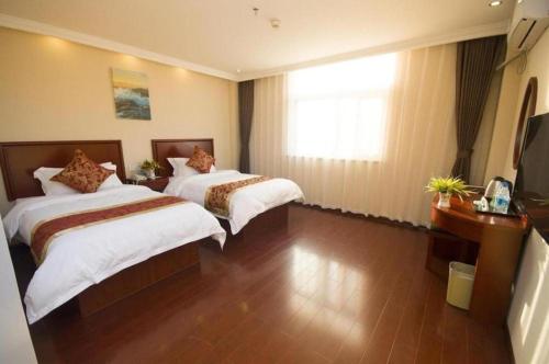 a hotel room with two beds and a window at GreenTree Inn Hefei Huangshan Road Daxidi 1912 Express Hotel in Hefei