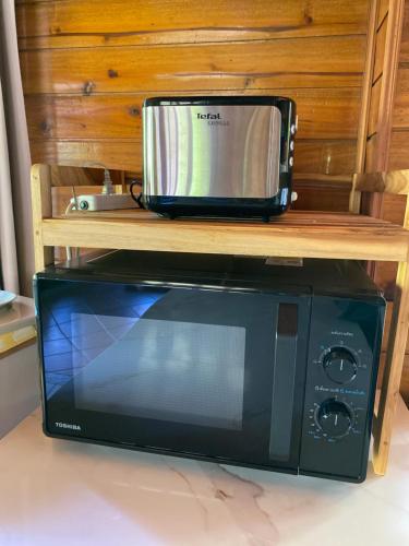a microwave oven sitting on top of a table at Baan Laem Noi Villa's in Mae Nam